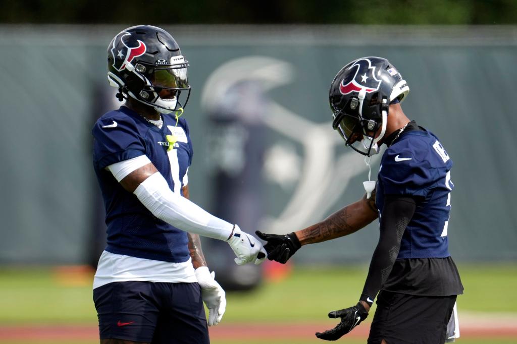 Houston Texans wide receivers Stefon Diggs and Tank Dell joining fingers at NFL practice, May 30, 2024 in Houston