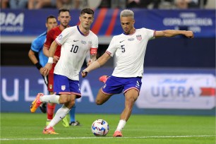 Group of Team USA soccer players, including Christian Pulisic, playing football