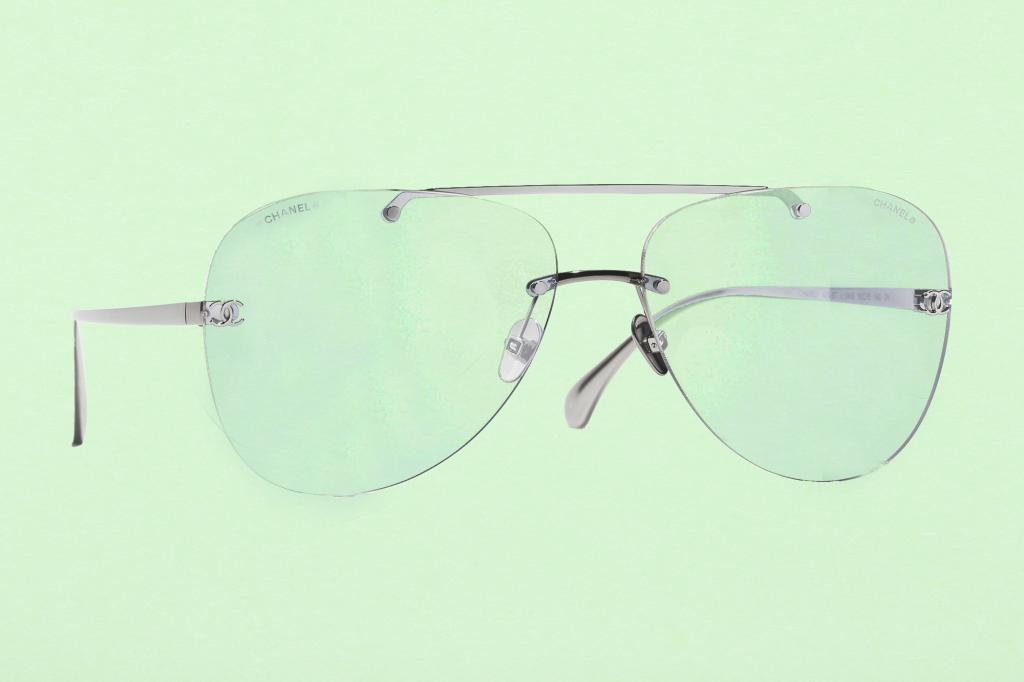 Closeup of a fresh green paper texture background with a pair of clear lens glasses on top
