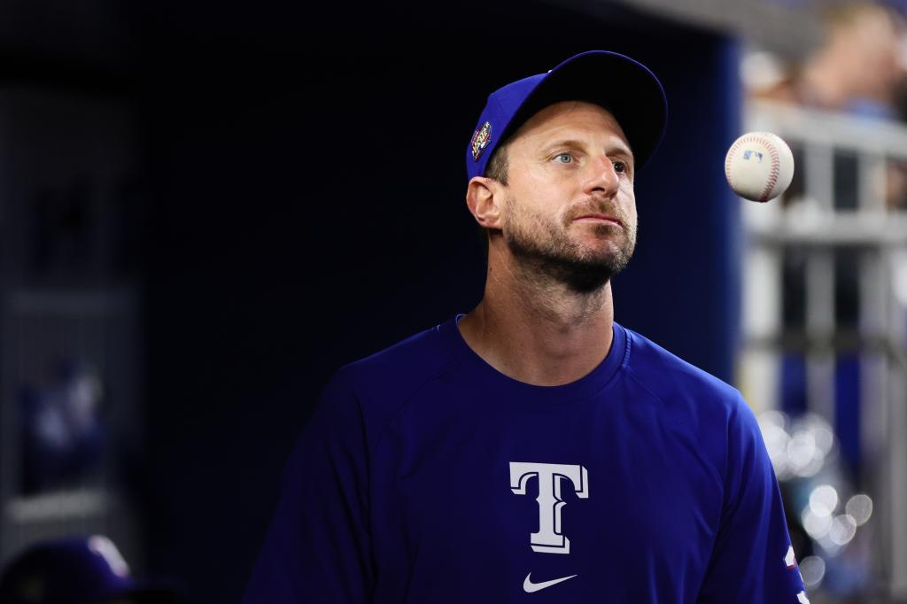 Texas Rangers starting pitcher Max Scherzer, in uniform, looking on from the dugout at loanDepot Park during game against Miami Marlins