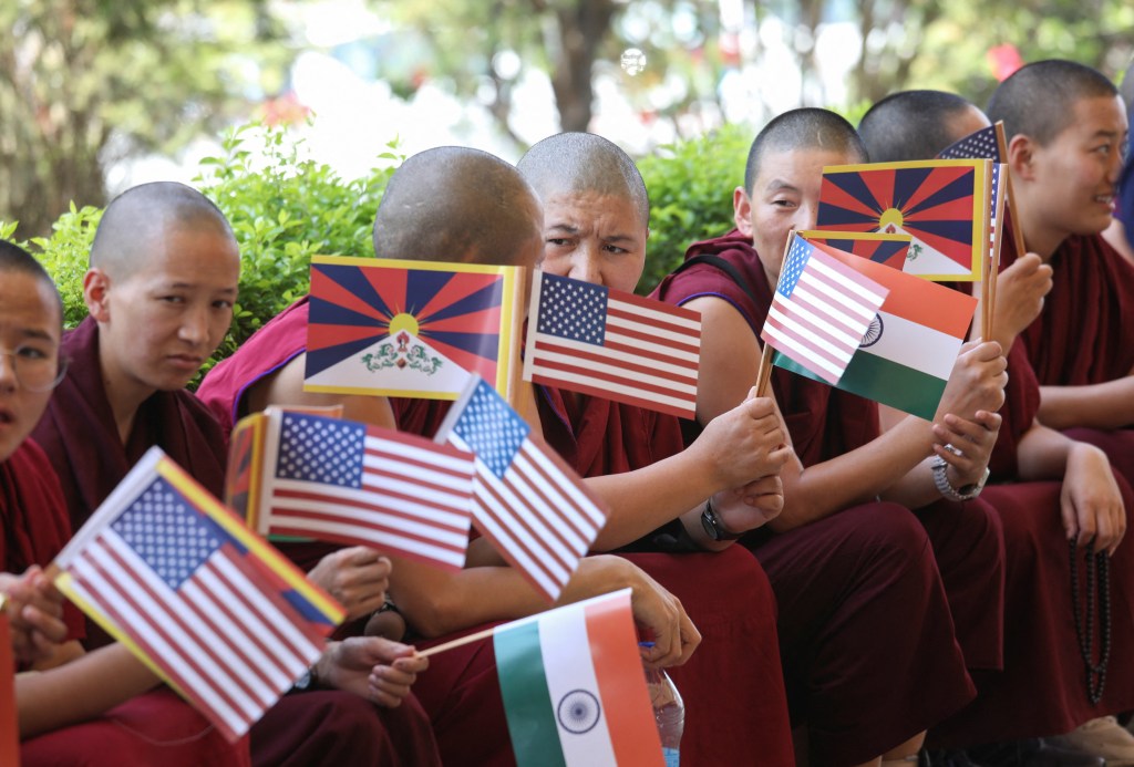 Tibetan nuns holding the U.S., Indian and Tibetan flags wait to welcome a bipartisan U.S. congressional delegation, led by Republican Representative Michael McCaul and including Democratic former House Speaker Nancy Pelosi at the Kangra airport in Kangra, Himachal Pradesh, India June 18, 2024. 