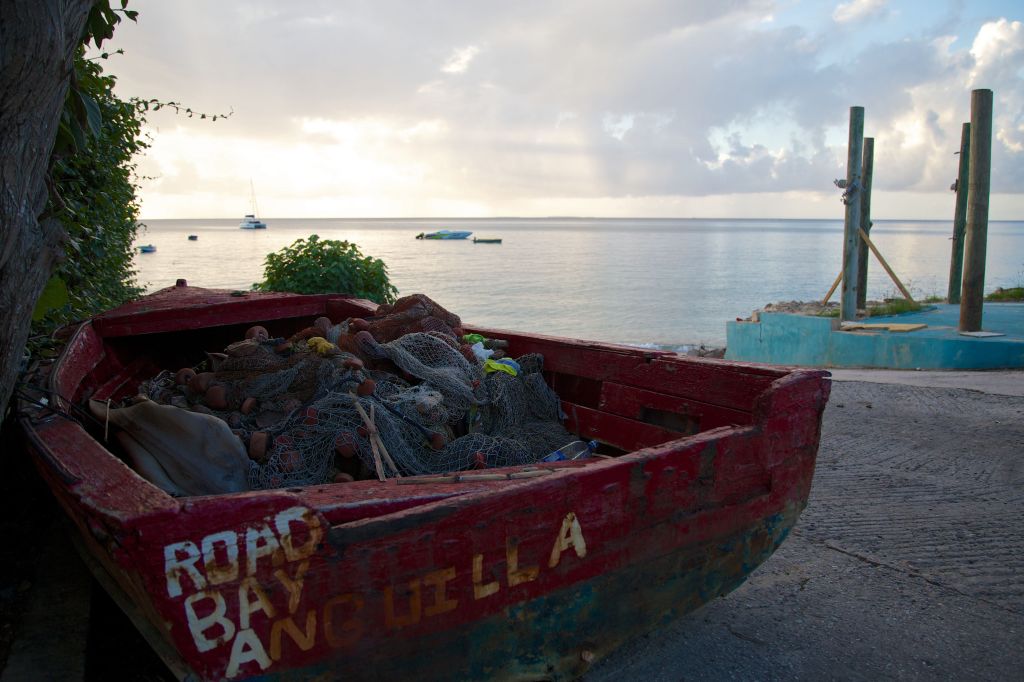 a small fishing boat sits on the seashore in Anguilla, a British overseas territory