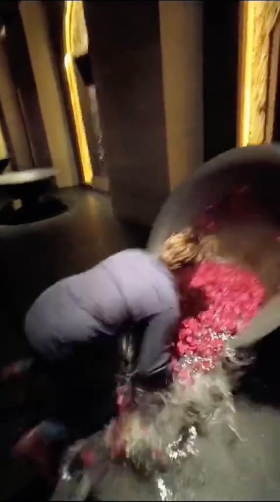 Tourist at Apurva Kempinski hotel in Bali interacting with a decorative water bowl, sparking debate on social media