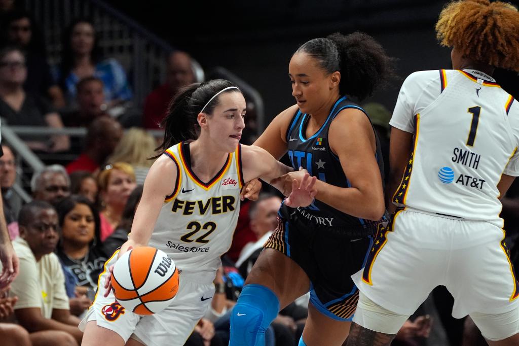 Indiana Fever guard Caitlin Clark (22) tries to get past Atlanta Dream guard Haley Jones (13) during the first half of a WNBA basketball game.