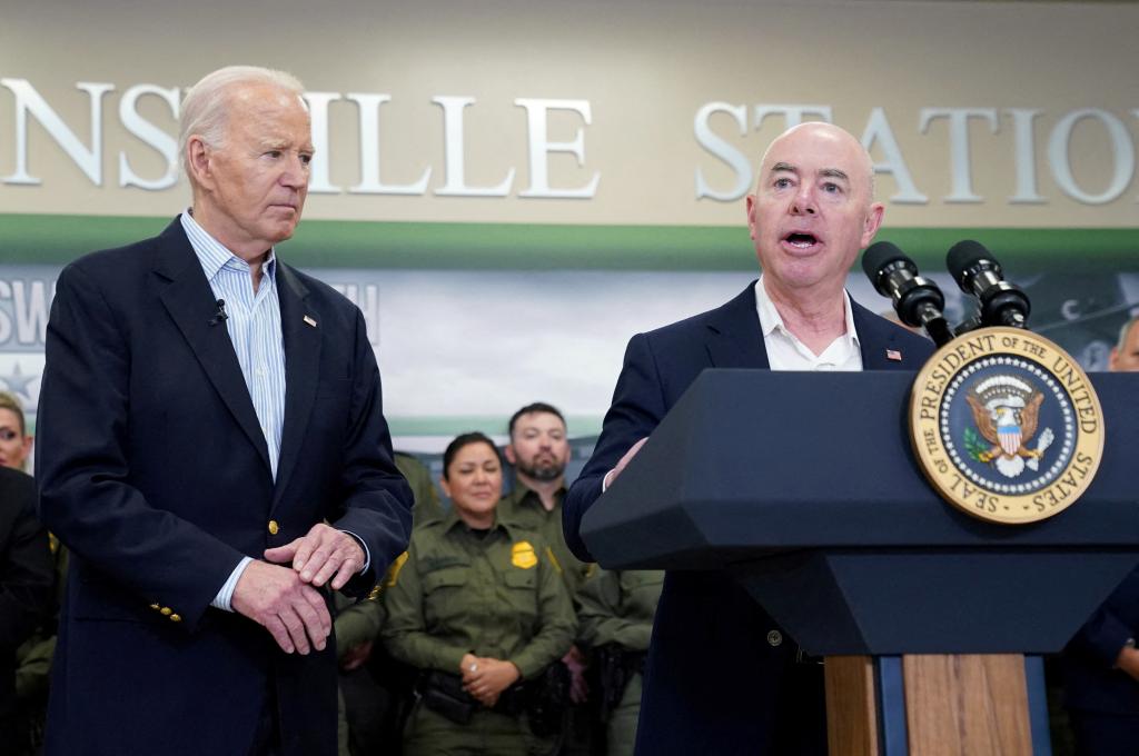 President Joe Biden and DHS Secretary Alejandro speak at the border in Brownsville, Texas before a podium and in front of a delegation of Border Patrol agents.