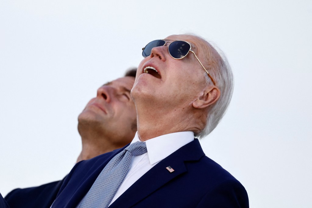 U.S. President Joe Biden and France's President Emmanuel Macron look on during a flag ceremony on the first day of the G7 summit, in Savelletri, Italy, June 13, 2024. 