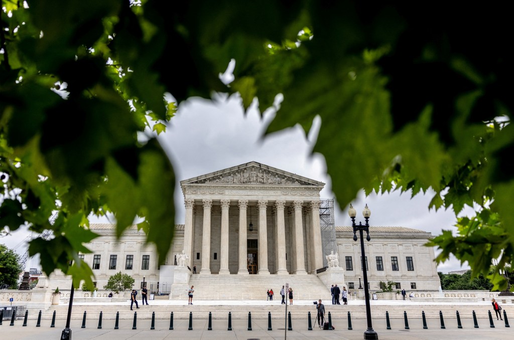 U.S. Supreme Court building with columns and people in front of it in Washington, U.S., May 20, 2024.