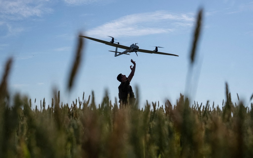 A Ukrainian serviceman launches a reconnaissance drone