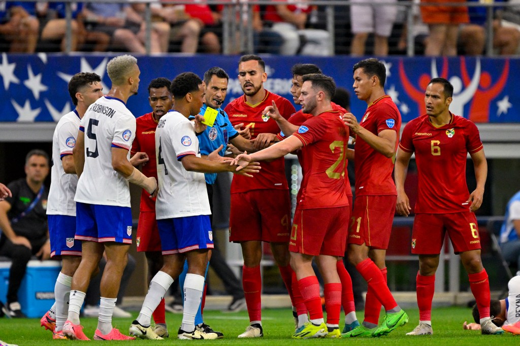 United States and Bolivia argue on the field after Bolivia midfielder Leonel Justiniano (6) receives a yellow card for fouling United States midfielder Giovanni Reyna (7) during the first half in a 2024 Copa America match  on Sunday.