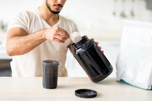 Guy making a protein shake.