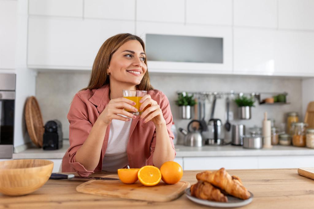 A woman holding a glass of orange juice, symbolizing Gen Z-approved ways to test love as cited by TikTokers.