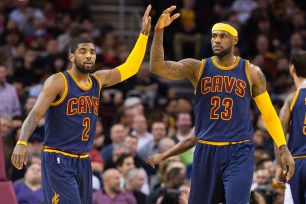 Kyrie Irving #2 and LeBron James #23 of the Cleveland Cavaliers celebrate during the first half against the Golden State Warriors at Quicken Loans Arena on February 26, 2015 in Cleveland, Ohio.