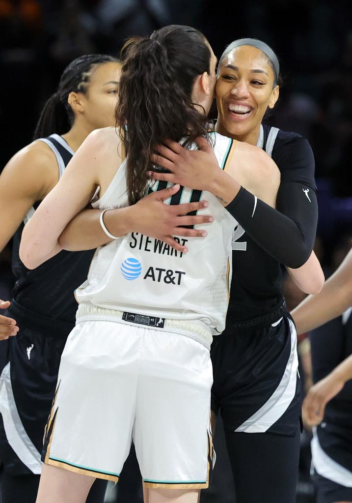 Breanna Stewart of the New York Liberty and A'ja Wilson of the Las Vegas Aces hugging at midcourt before their game