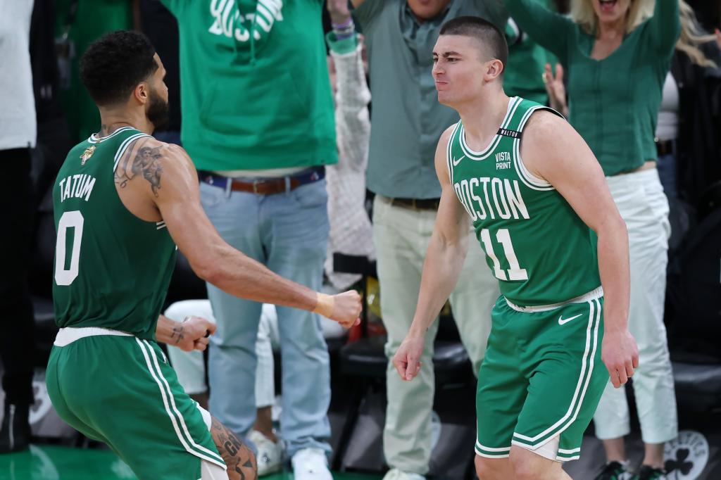 Jayson Tatum #0 celebrates with Payton Pritchard #11 of the Boston Celtics after Pritchard's half court shot at the buzzer against the Dallas Mavericks during the second quarter of Game Five of the 2024 NBA Finals at TD Garden on June 17, 2024 in Boston, Massachusetts.  