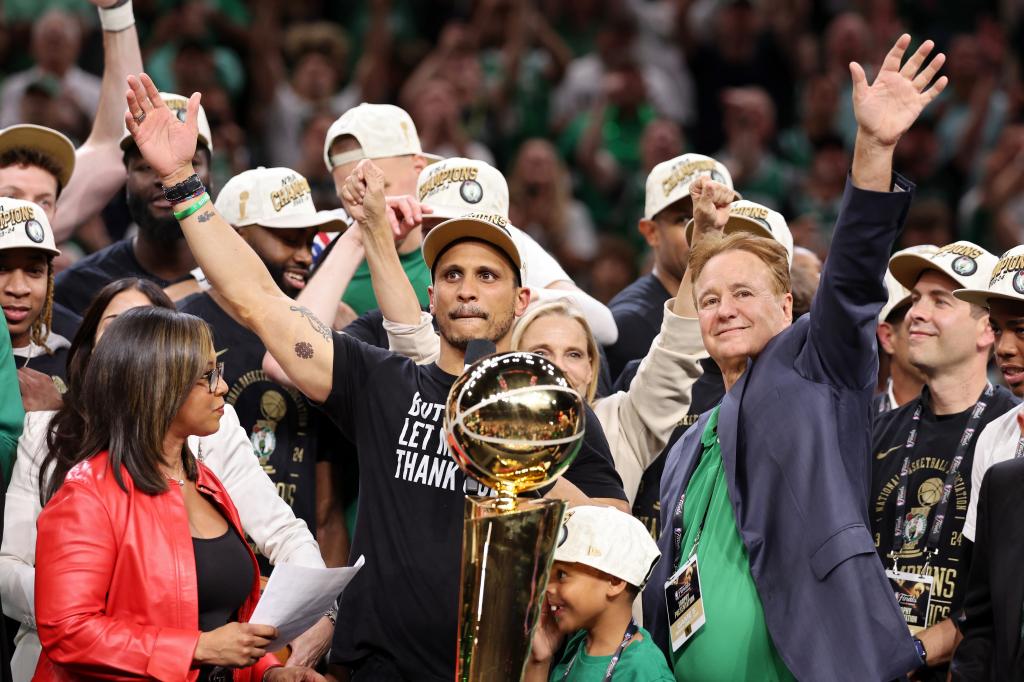 Head coach Joe Mazzulla of the Boston Celtics holds the Larry O'Brien championship trophy after beating the Dallas Mavericks in Game Five of the 2024 NBA Finals at TD Garden on June 17, 2024 in Boston, Massachusetts.  