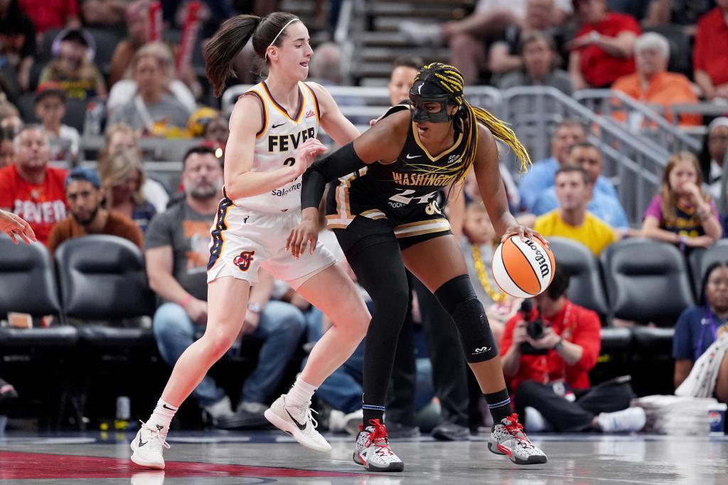 Aaliyah Edwards of the Washington Mystics drives against Caitlin Clark of the Indiana Fever on Wednesday. 