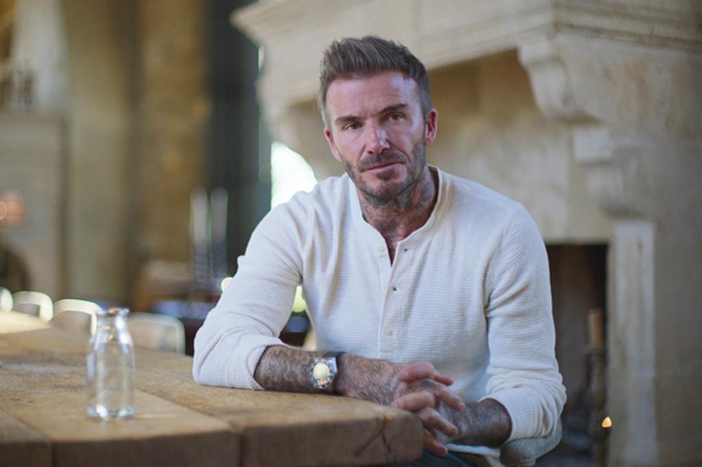 David Beckham sitting at a table during an interview in the Beckham documentary