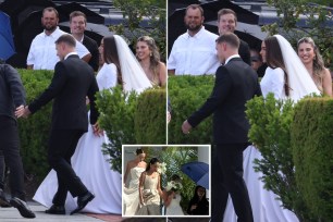 Olivia Culpo and Christian McCaffrey at their wedding, with a group of people walking in wedding attire