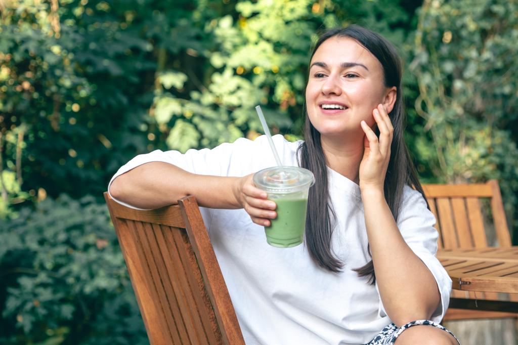 Woman enjoying a matcha latte at an outdoor cafe