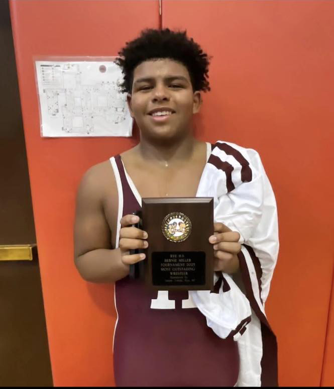 Mark Anthony Giordano holding a plaque in a memorial social media post by Harrison Wrestling