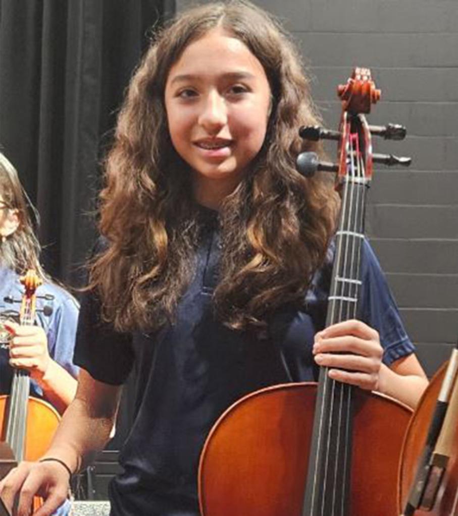 Jocelyn Nungaray is seen holding a cello alongside her peers.