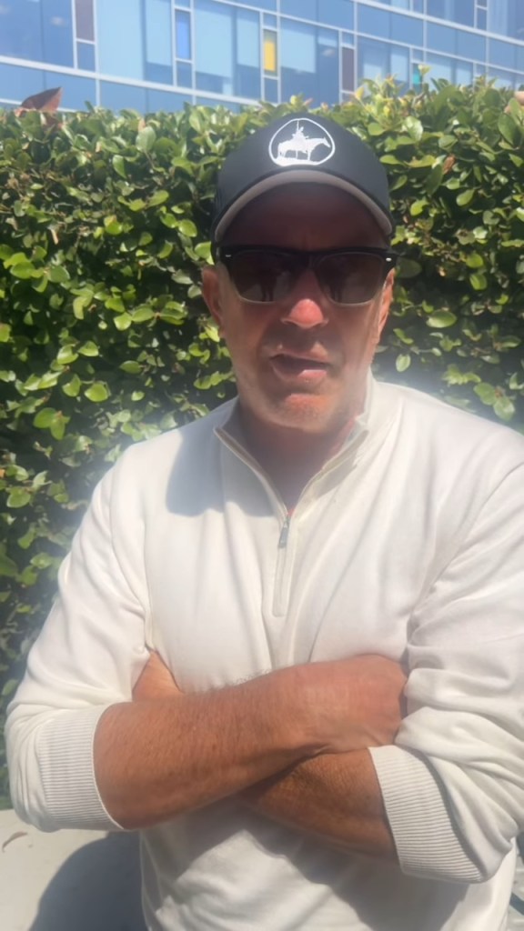 Kevin Costner wearing sunglasses and a hat
