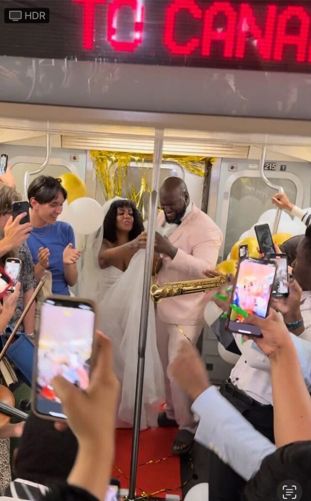 Daniel Jean, 39, and Esmy Valdez, 38, from Flatbush, enjoying their subway wedding reception. 