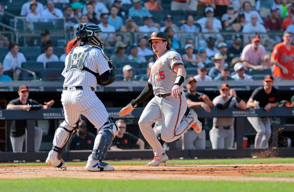 Adley Rutschman #35 of the Baltimore Orioles scores on Ryan Mountcastle #6 of the Baltimore Orioles bases clearing RBI double during the second inning.