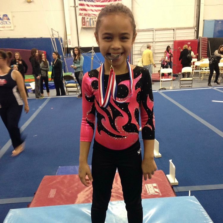 Hezly River in a gymnastics outfit during her first level 3 competition