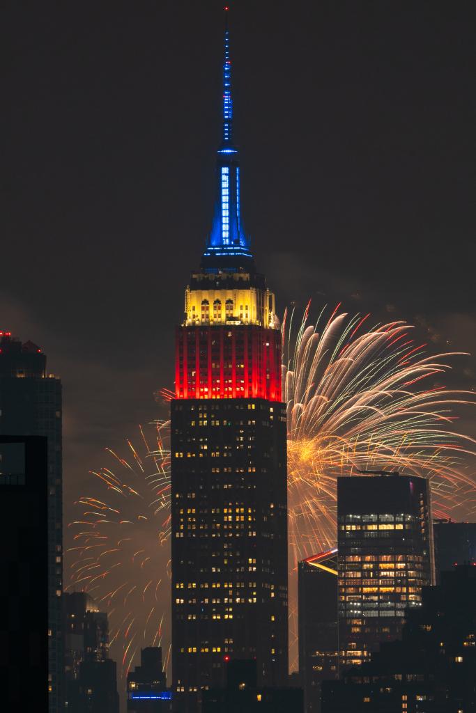 A firework goes off behind the Empire State Building, which was lit up in Red, White and Blue on July 4, 2024.