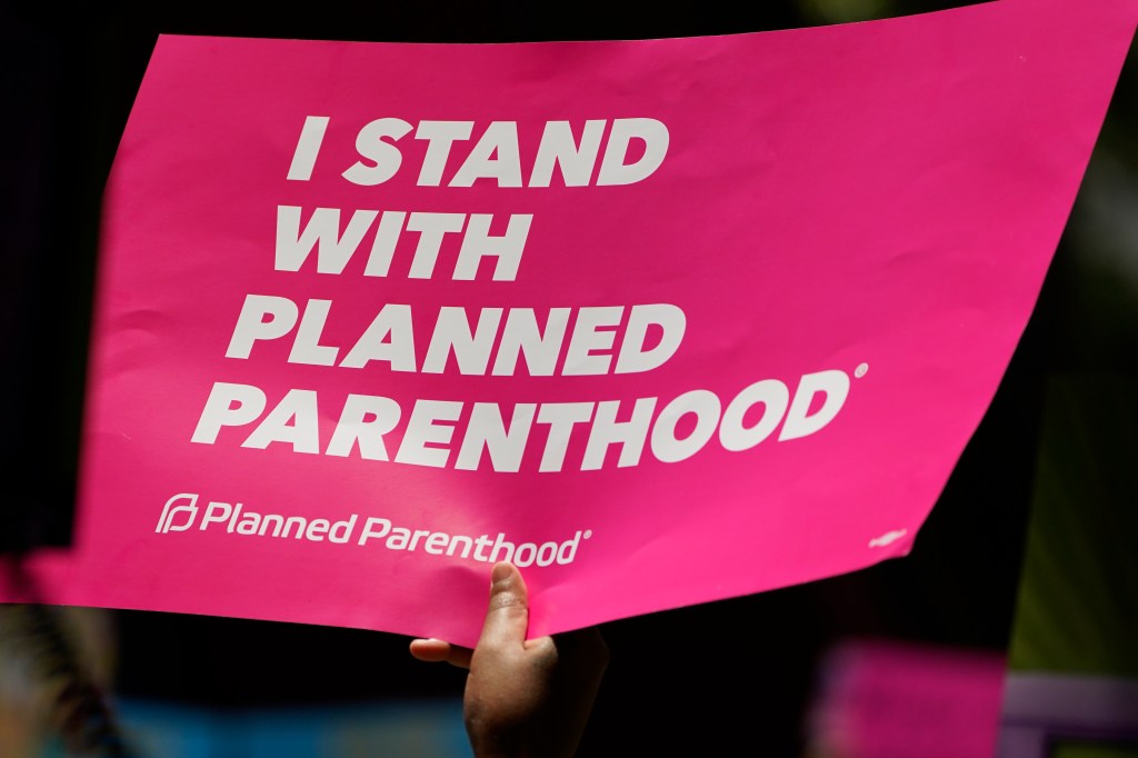 An abortion rights supporter waving a Planned Parenthood sign in Jackson, Mississippi on June 17, 2022