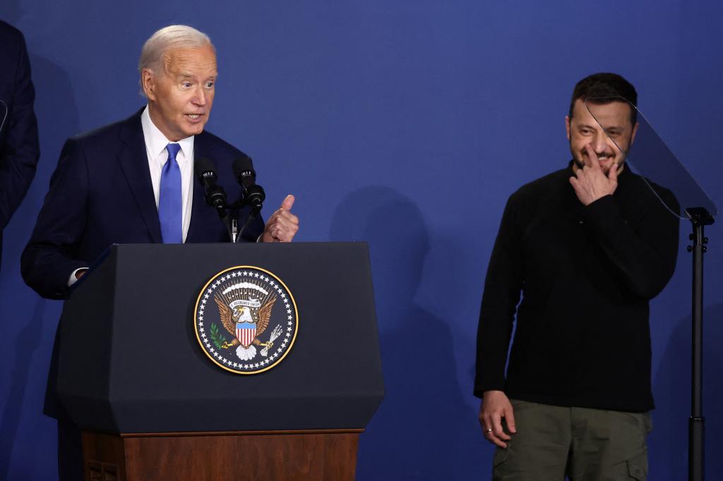 U.S. President Joe Biden speaks at a Ukraine Compact meeting, as Ukraine's President Volodymyr Zelenskiy stands next to him, on the sidelines of the NATO's 75th anniversary summit in Washington.