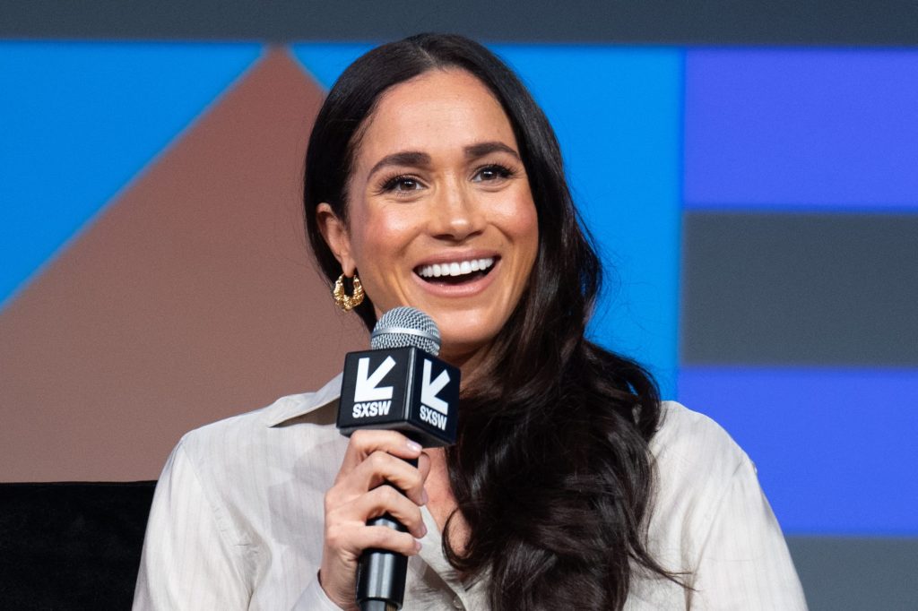 Meghan, Duchess of Sussex, smiling at a microphone as she unveils her new business venture, American Riviera Orchard, at the SXSW 2024 Conference in Austin, Texas.