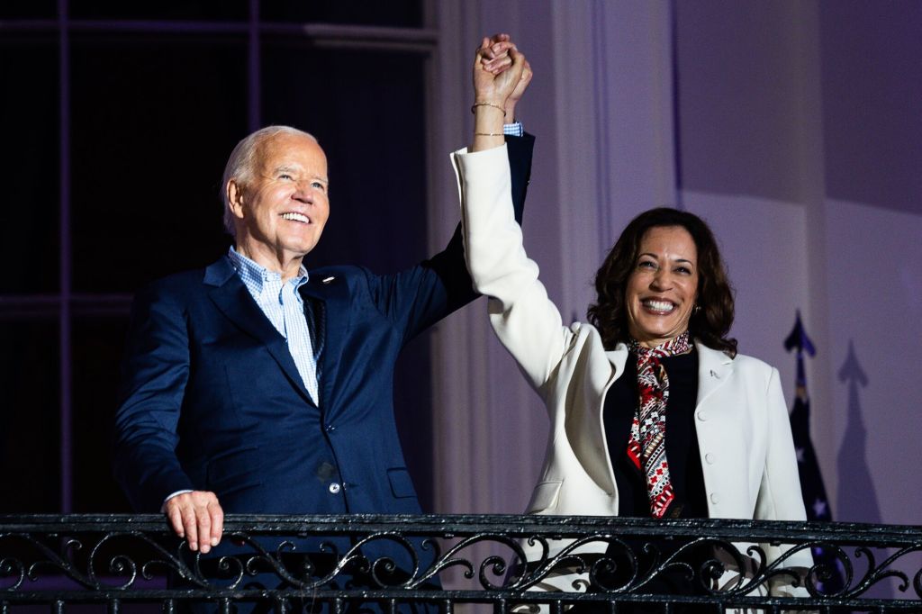 President Joe Biden and Vice President Kamala Harris standing on the Truman Balcony at the White House during a Fourth of July celebration in 2024