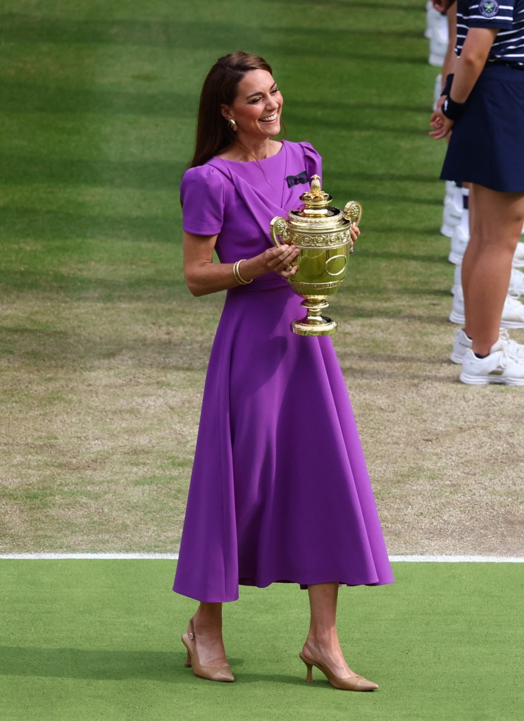 Princess Catherine of Britain in a purple dress holding the Wimbledon men's singles trophy before presenting it to the winner