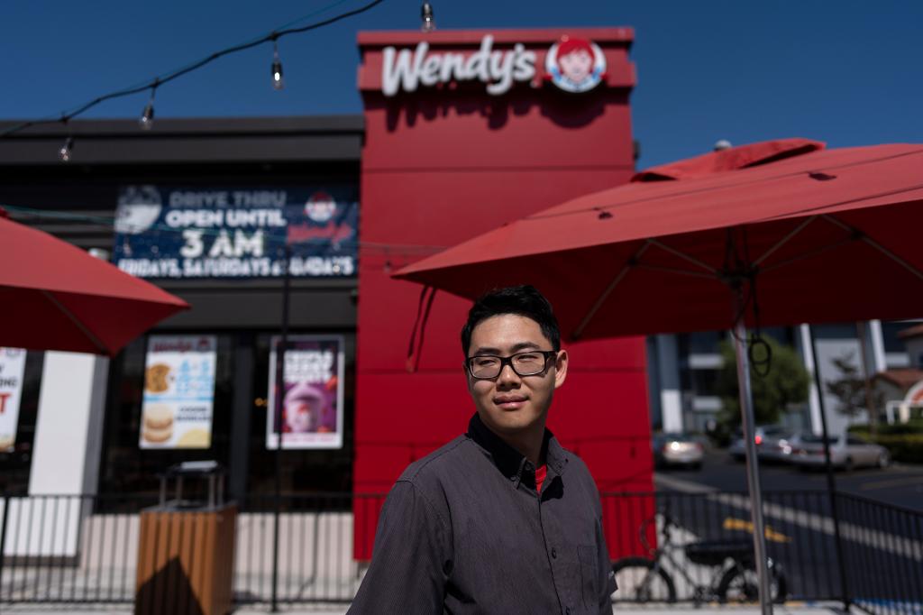 Lawrence Cheng outside his Wendy's restaurant in Fountain Valley, adjusting to increased labor costs due to new California wage law