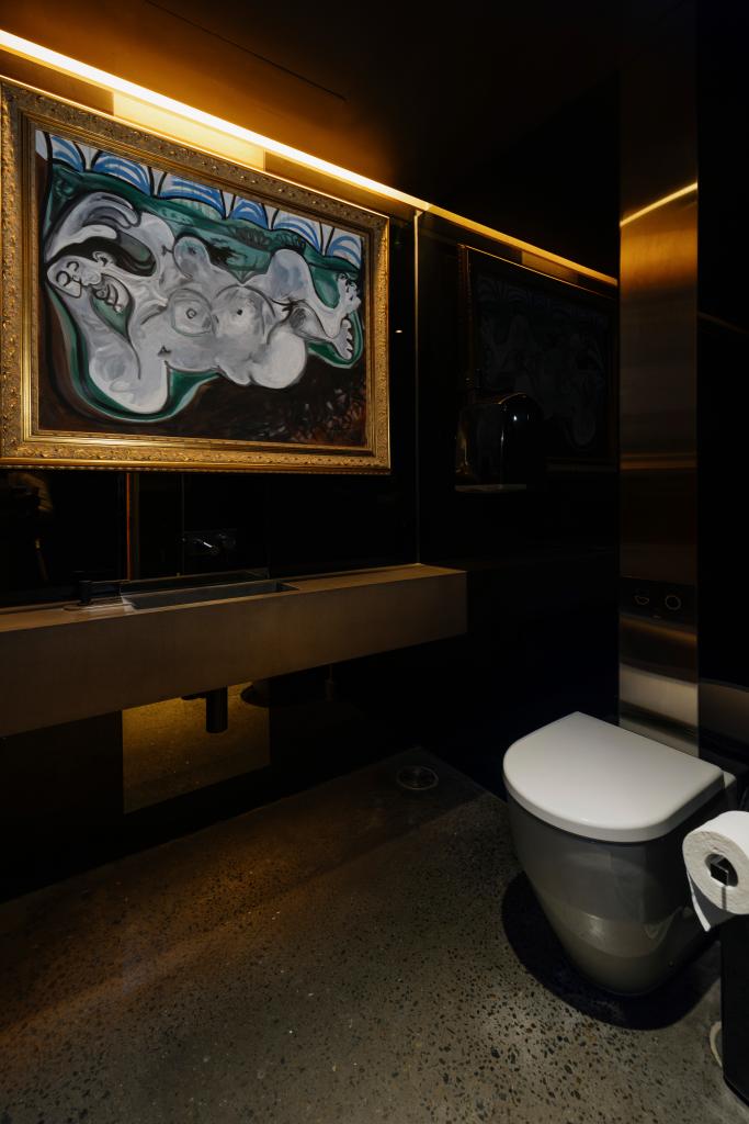 The Ladies Lounge in the Museum of Old and New Art was turned into a women's bathroom by adding a toilet, seen in the photo in front of one of the fake Picassos hanging in the room. 