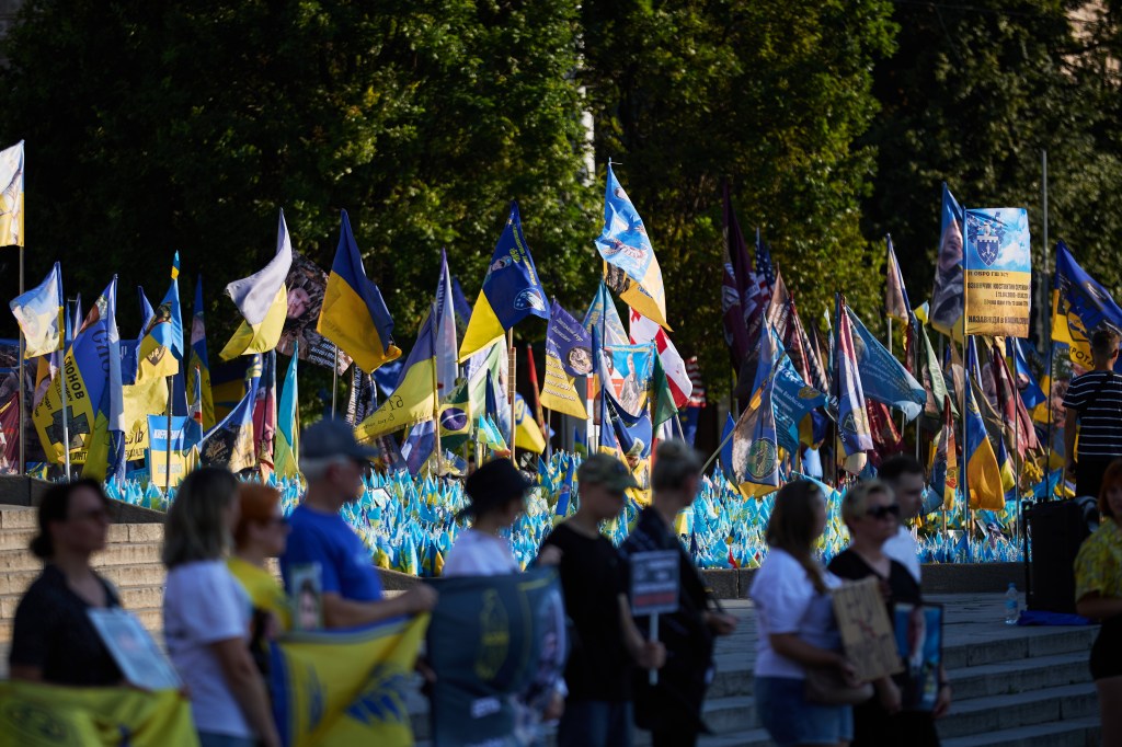 Ukrainians seen holding a rally for fallen loved ones.