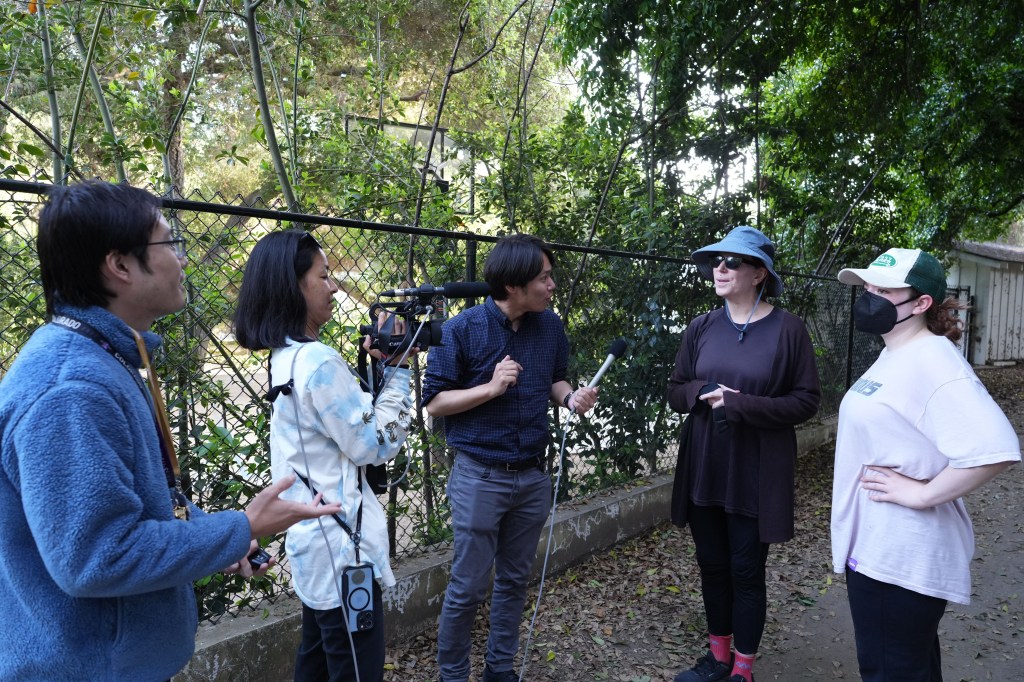 Shingo Wada (left) and Fuji TV media members interview residents outside a mansion house purchased by Los Angeles Dodgers player Shohei Ohtani.