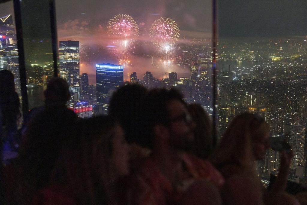 Guests of the Summit observatory watch Macy's Fourth of July fireworks in New York, New York.