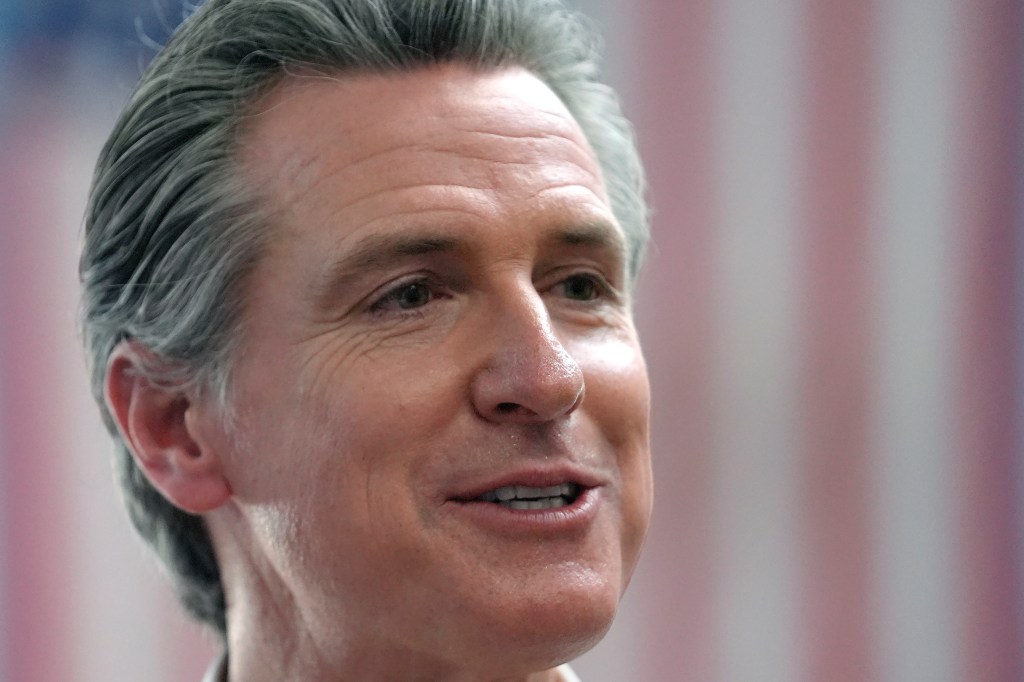 California Governor Gavin Newsom greeting people outside the Common Man Roadside Market and Deli in Hooksett, N.H., in support of the living wage bill