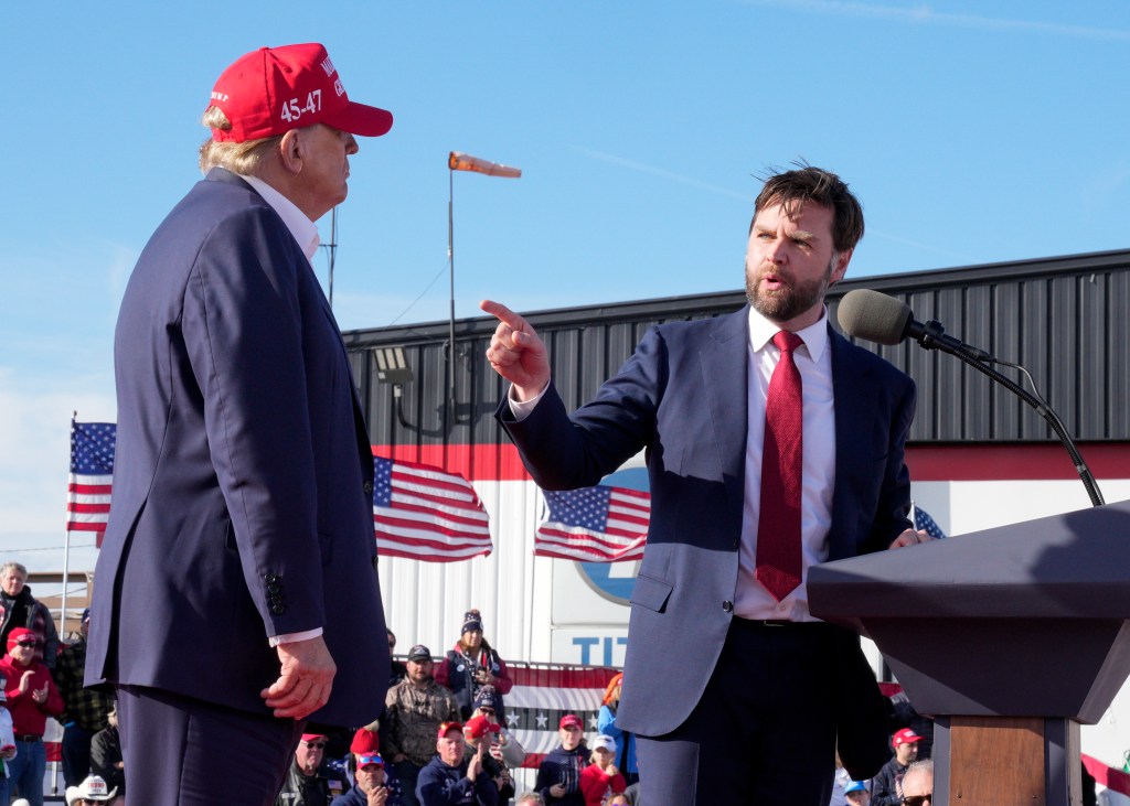 Ohio Senator JD Vance points towards Donald Trump during the former president's campaign rally in Vandalia, Ohio on March 16, 2024.