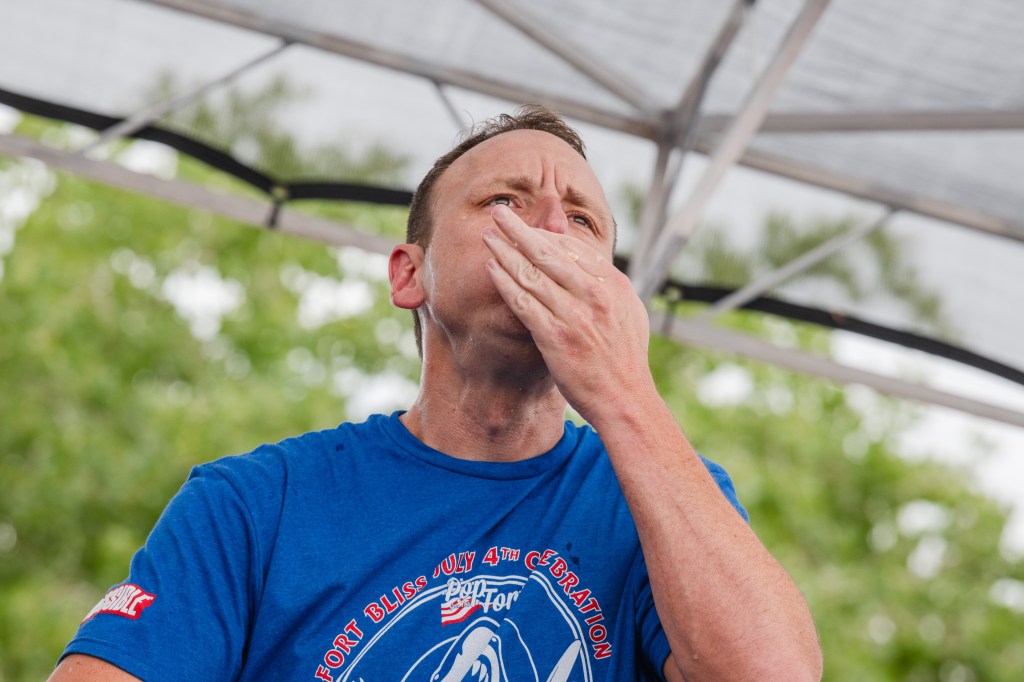 Joey Chestnut on his way to eating 57 hotdogs in five minutes at the Pop Goes the Fort eating contest on Fort Bliss, Texas on July 4, 2024.