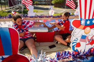 Children throw ice at each other during the Fishtown Horribles Parade, ahead of Independence Day, in Gloucester, Massachusetts on July 3, 2024.