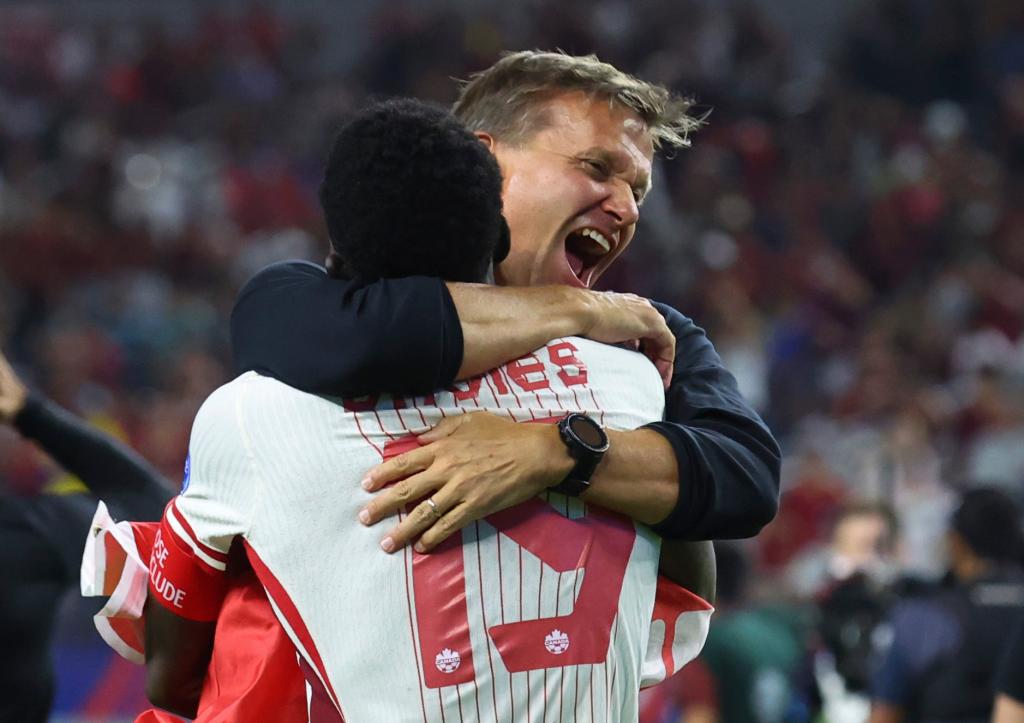 Canada defender Alphonso Davies (19) celebrates with head coach Jesse Marsch after their win over Venezuela in a Copa America quarterfinal soccer match in Arlington, Texas, Friday, July 5, 2024.