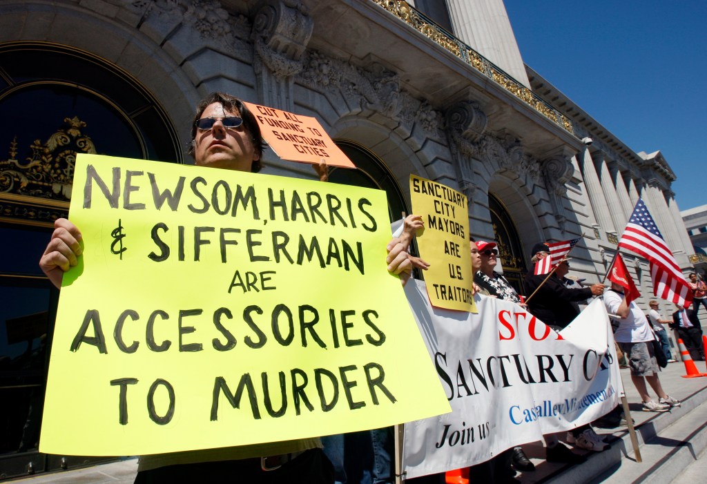 David Karner, left, and about a dozen MInutemen and their supporters stands on the steps of City Hall to call for Mayor Gavin Newsom's resignation in San Francisco, Calif., on Wednesday, July 30, 2008.