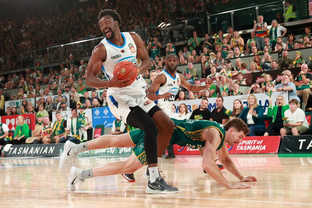 Ariel Hukporti of United passes against Will Magnay of the JackJumpers during game four of the NBL Championship Grand Final Series between Tasmania JackJumpers and Melbourne United at MyState Bank Arena, on March 28, 2024, in Hobart, Australia. 