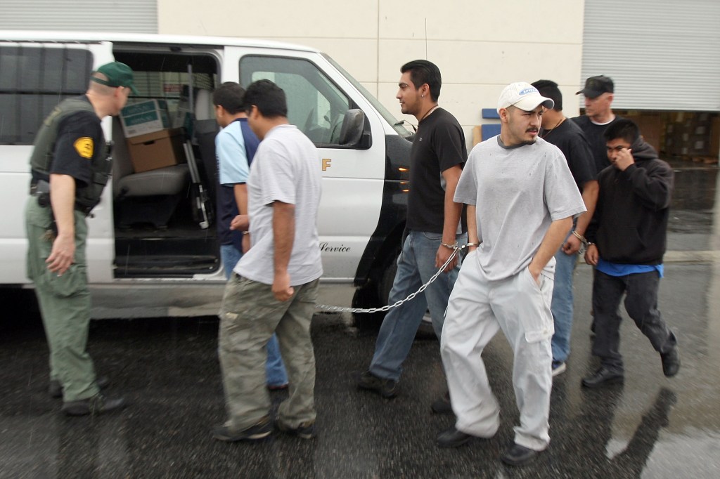 Sheriff Deputies arrest six Latino men while detaining about 52 predominantly Latino immigrant workers inside a DVD manufacturing plant as they investigate a possible identity fraud case on February 5, 2009 in Santa Clarita, California.