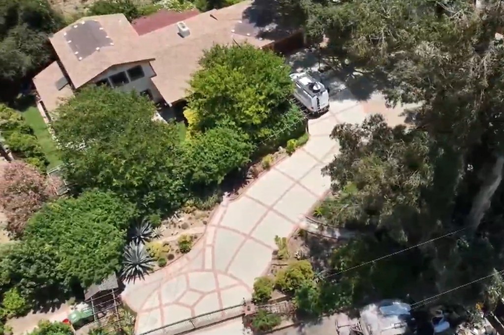 A view of the Malone's driveway, which is slowly being infested by junk from her neighbor.