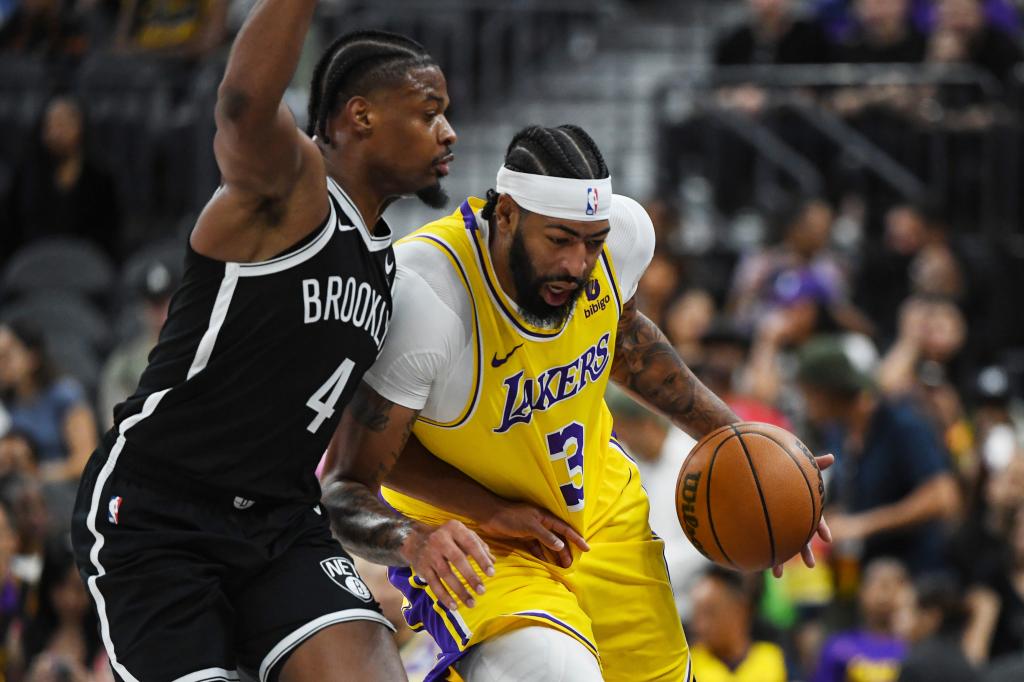 Brooklyn Nets guard Dennis Smith Jr. (4) defends against Los Angeles Lakers forward Anthony Davis (3) during the first half of a preseason NBA basketball game Monday, Oct. 9, 2023, in Las Vegas